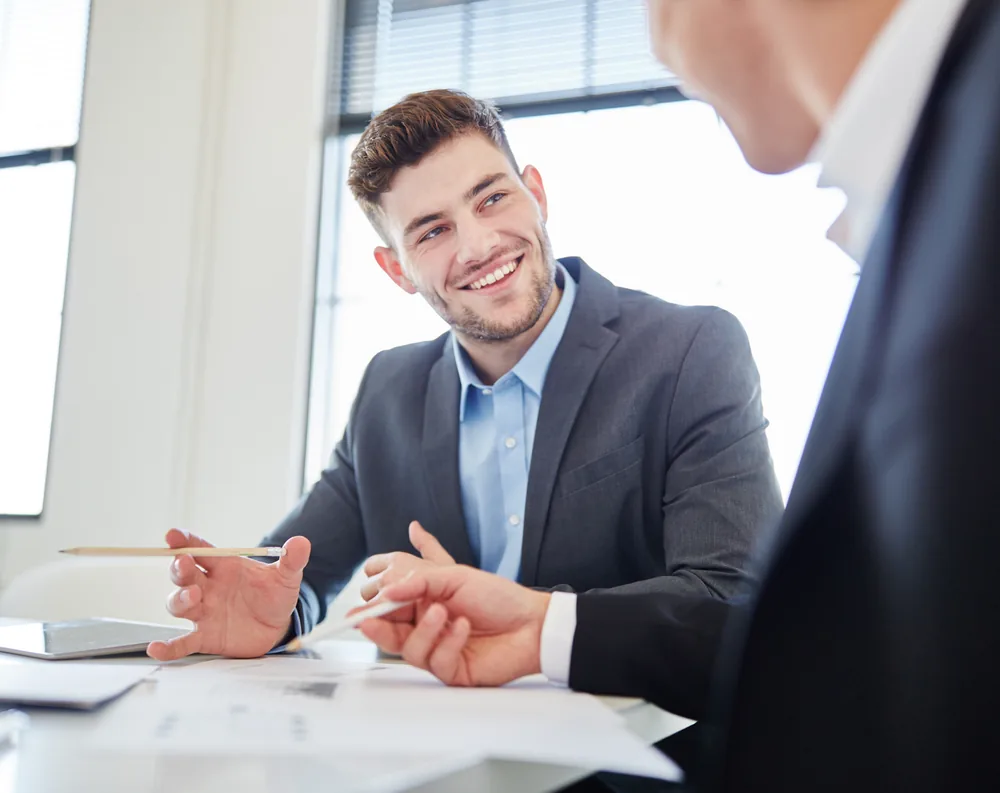 HR advisor reviewing documents with a client in a bright office