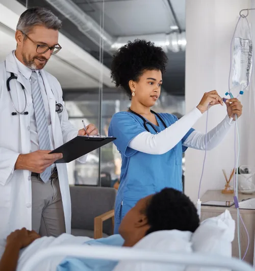 Doctor and nurse attending to a patient in a hospital room